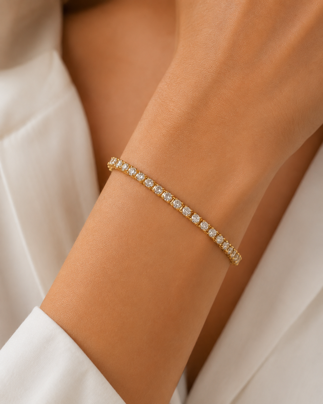 Model wearing gold-plated clear tennis bracelet, 6-inch size