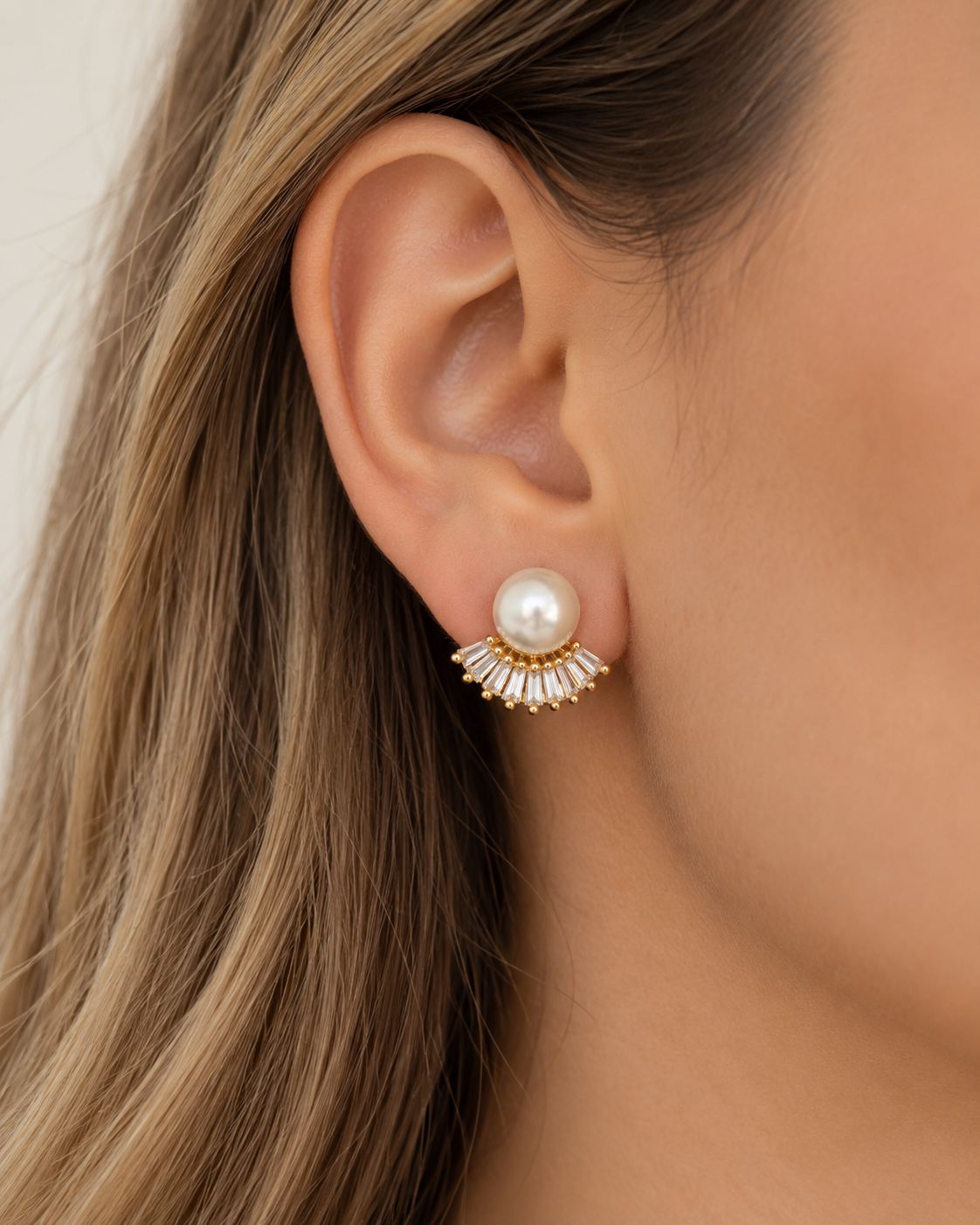 Model wearing COMPLIMENTI gold-plated pearl and crystal fan stud earrings