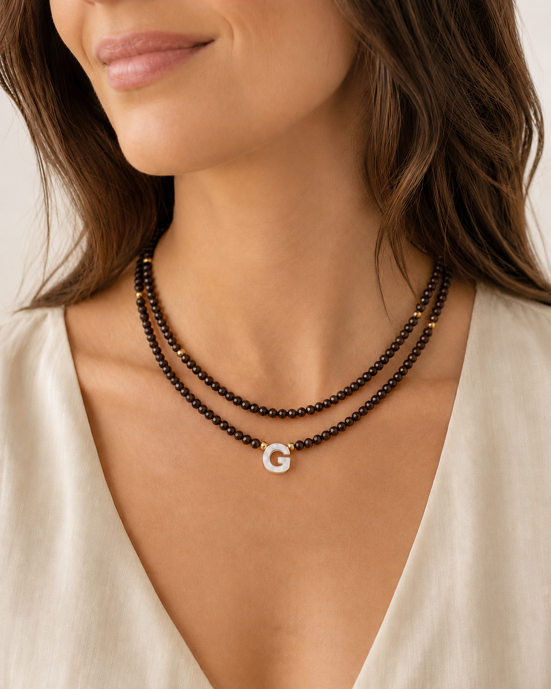 Model wearing chocolate personalized double glass bead necklaces in 16 and 18 inch lengths