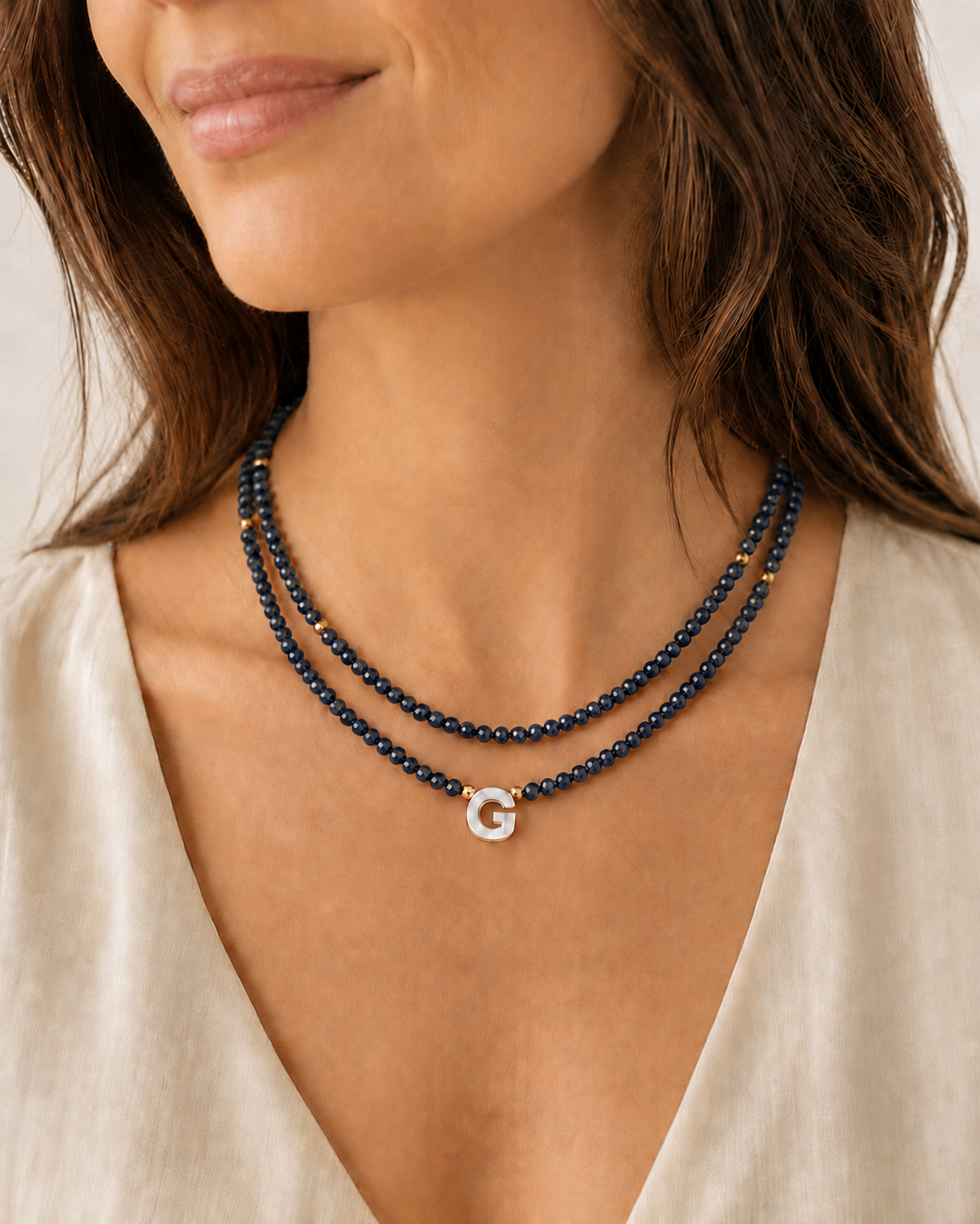 Model wearing dark navy personalized double glass bead necklaces in 16 and 18 inch lengths
