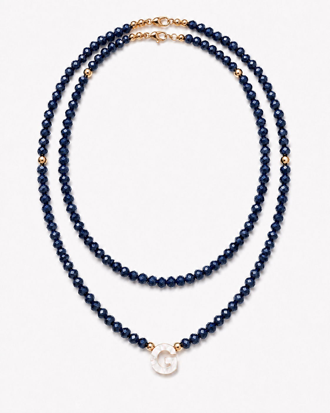 Dark navy personalized double glass bead necklace set with mother-of-pearl initial on white background