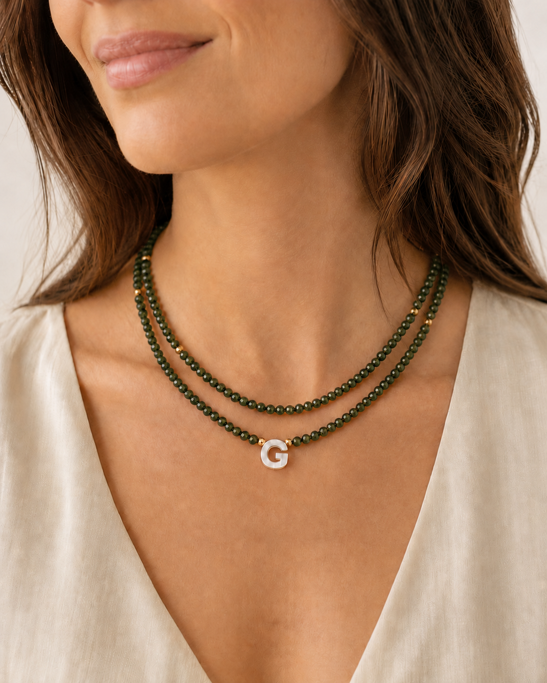 Model wearing dark military green personalized double glass bead necklaces in 16 and 18 inch lengths