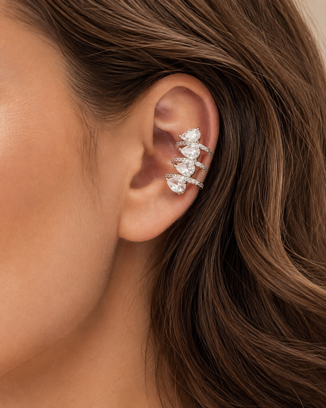 Model wearing a gold-plated teardrop crystal ear cuff
