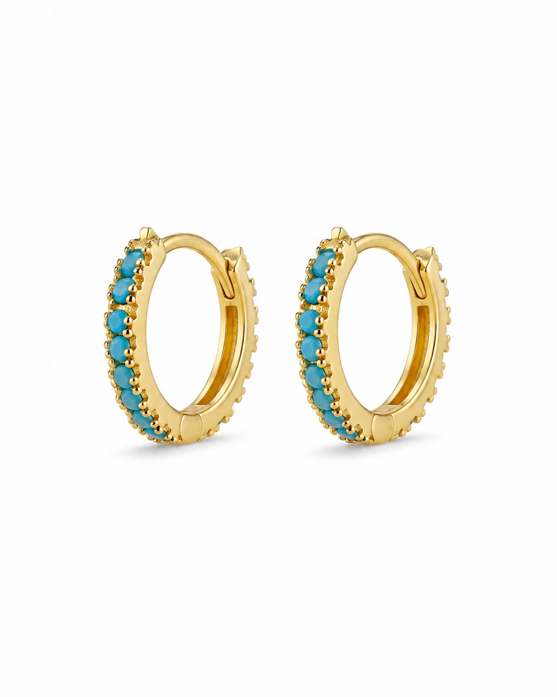 Gold-plated turquoise huggie earrings on white background