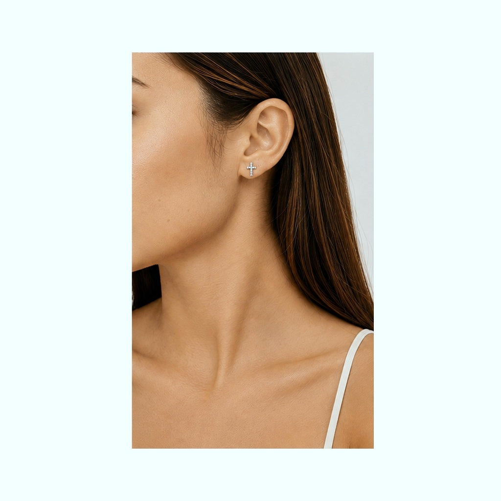Model wearing Cross CZ stud earrings in 925 sterling silver