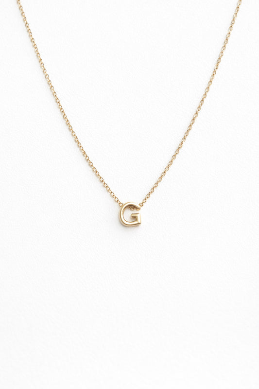 Personalized gold-plated initial necklace on white background