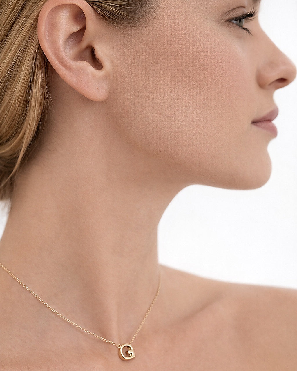 Woman wearing a personalized gold-plated initial necklace
